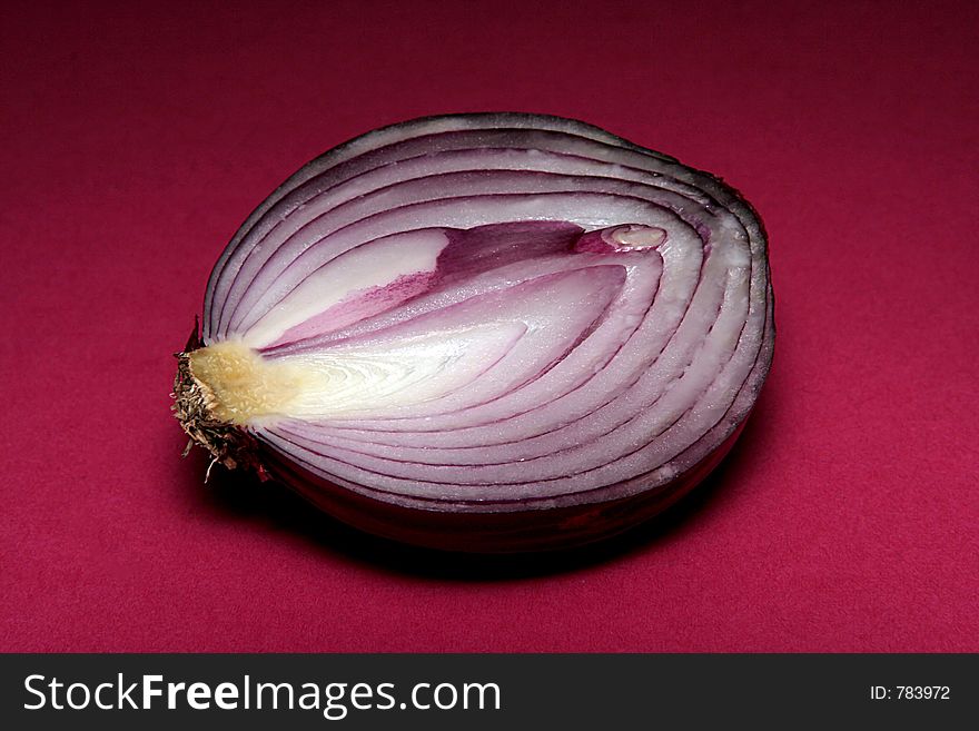 Red onion cut with dark red background