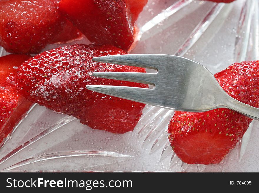 Delicious strawberry and a fork. Delicious strawberry and a fork