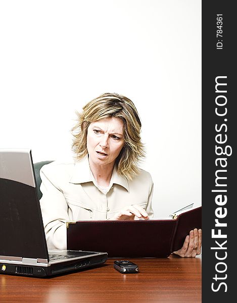 Business woman looking at laptop in boardroom