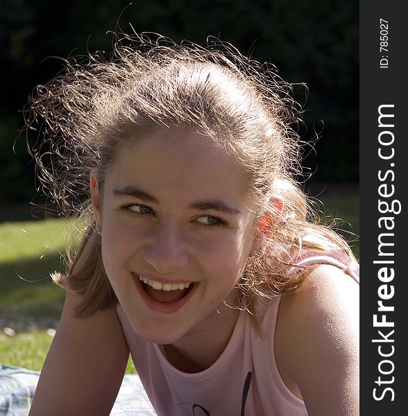 Close-up portrait of a laughing teenage girl. Close-up portrait of a laughing teenage girl