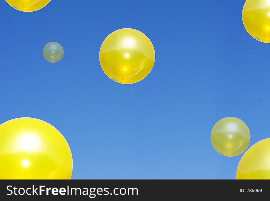 Large Yellow spheres floating in a blue sky. Large Yellow spheres floating in a blue sky