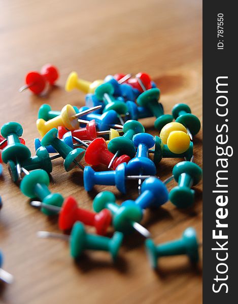 Close up of various Coloured Drawing Pins On Wooden Surface. Close up of various Coloured Drawing Pins On Wooden Surface