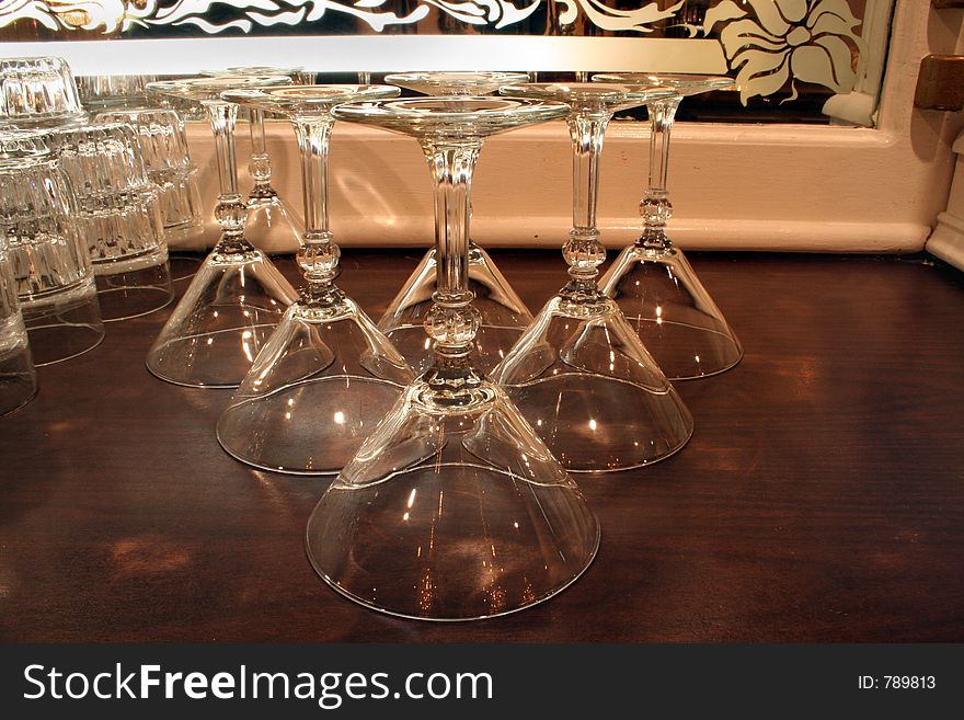 A set of martini glasses on a bar. A set of martini glasses on a bar