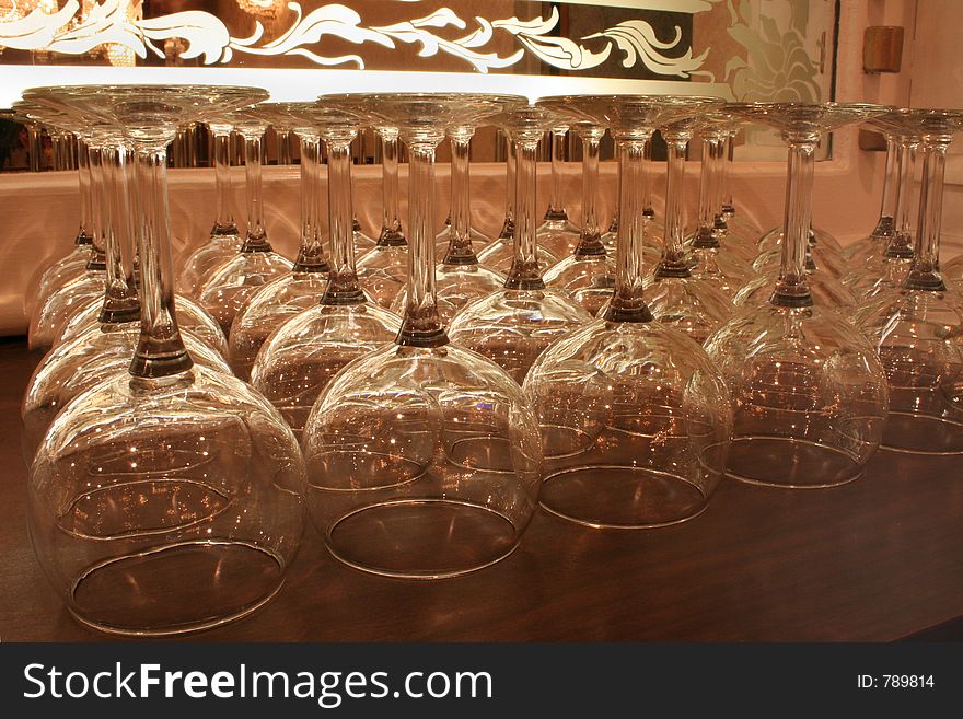 A set of wine glasses on a bar. A set of wine glasses on a bar