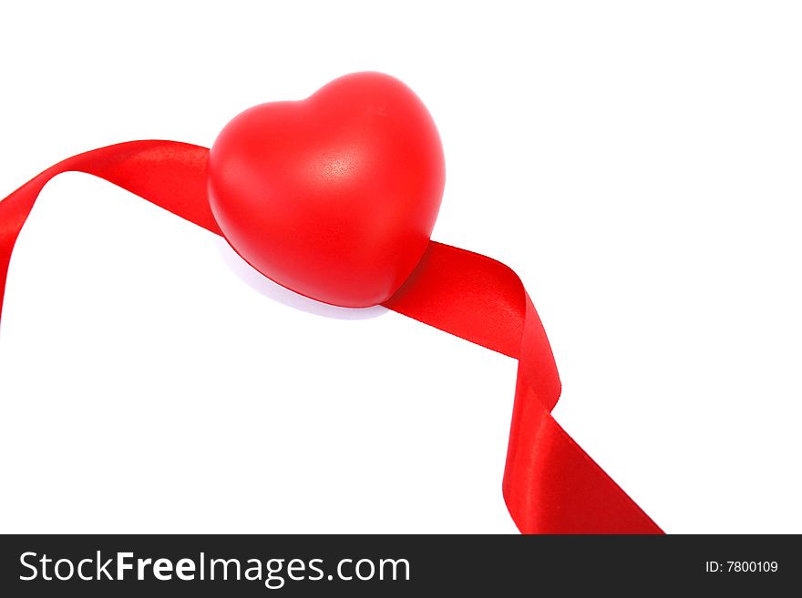 Red valentine heart and ribbon on white background.