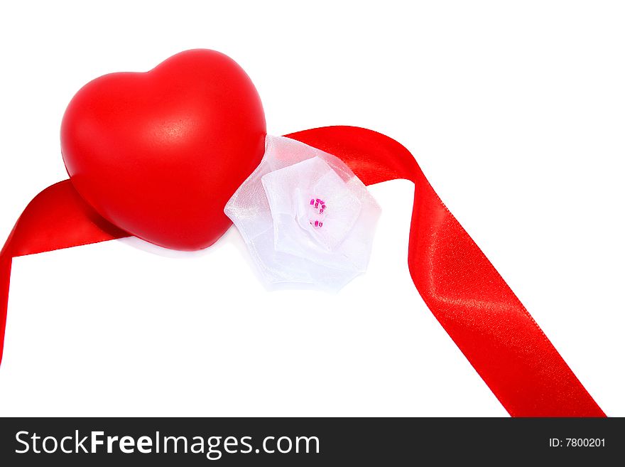 Red valentine heart, ribbon and white fabric flower on white background.