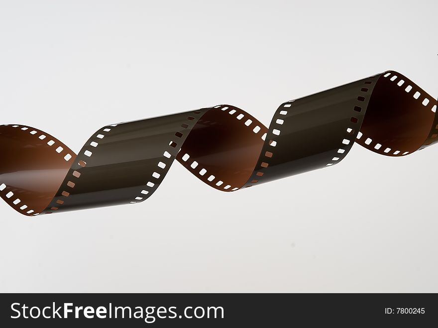 Strip of 35mm film coiled into a spiral on white background. Strip of 35mm film coiled into a spiral on white background