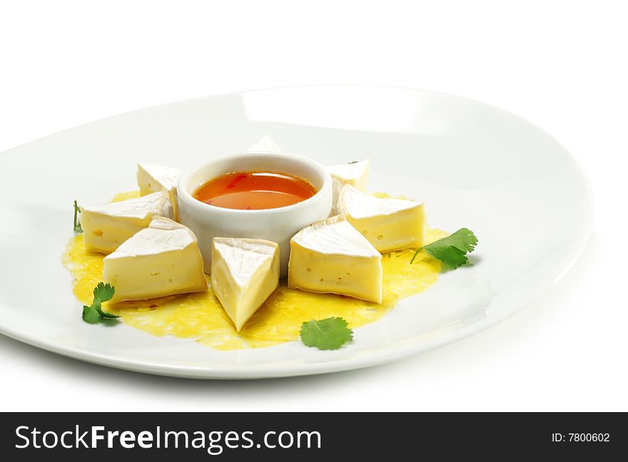 Fromage (Soft Cheese) with Honey Orange Sauce and Fresh Pineapple. Isolated on White Background. Fromage (Soft Cheese) with Honey Orange Sauce and Fresh Pineapple. Isolated on White Background