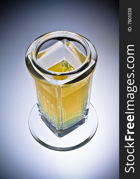 Laboratory glass beaker filled with a yellow chemical solution, isolated, vignette. Laboratory glass beaker filled with a yellow chemical solution, isolated, vignette.