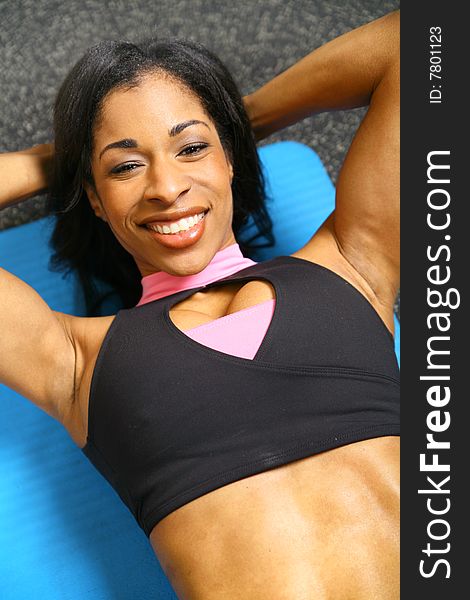 Close up african american woman training or exercising in gym, doing sit up. Close up african american woman training or exercising in gym, doing sit up