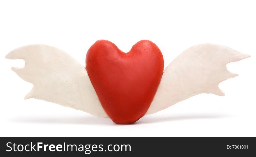 Heart made with plasticine with wings isolated on white. Heart made with plasticine with wings isolated on white