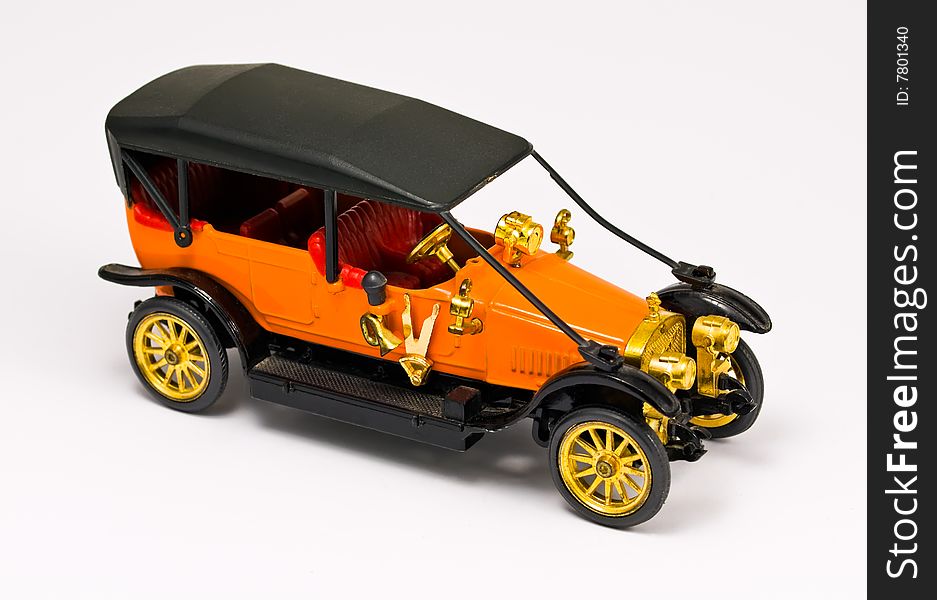 Model of retro orange car against white background. Model of retro orange car against white background