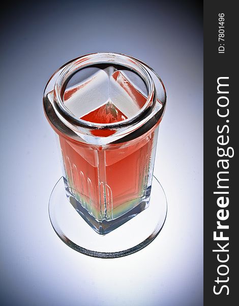 Laboratory glass beaker filled with red chemical solution, isolated, vignette.
