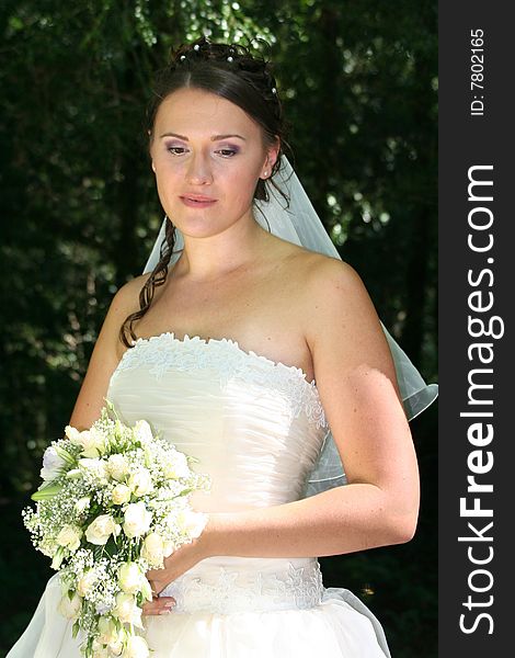 Sad bride holds a beautiful wedding bouquet
