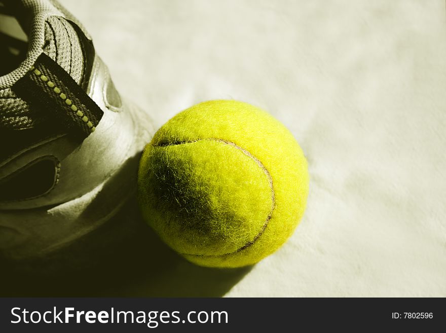 Yellow tennis ball with sneakers. Yellow tennis ball with sneakers