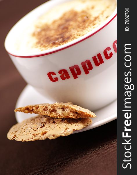 Closeup of a cup of cappuccino and biscottii. Closeup of a cup of cappuccino and biscottii