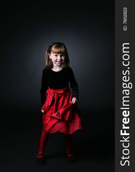 Pretty young girl spinning around in red dress. Pretty young girl spinning around in red dress