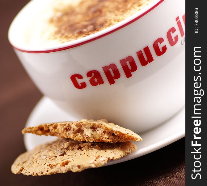 Closeup of a cup of cappuccino and biscottii. Closeup of a cup of cappuccino and biscottii