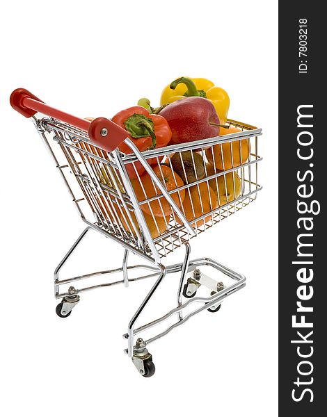 Shopping trolley with fruits and vegetables against a white background