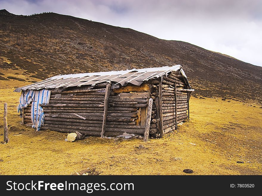 A log cabin of top of hill