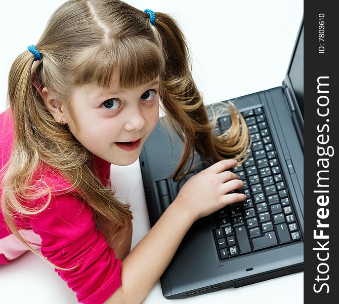 Stock photo: an image of a nice little girl with black laptop. Stock photo: an image of a nice little girl with black laptop