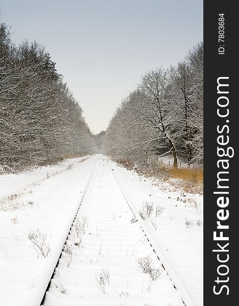 Snow landscape and railway track with pale blue sky. Snow landscape and railway track with pale blue sky