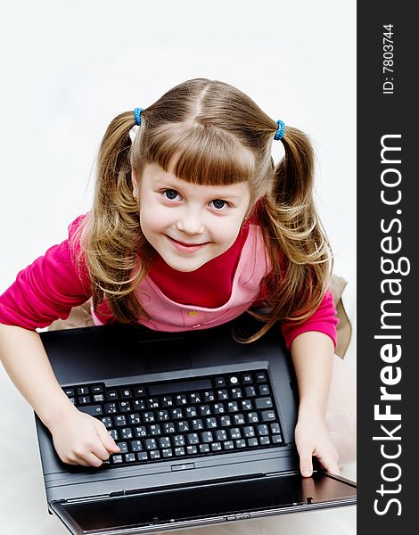 Stock photo: an image of a little girl with laptop