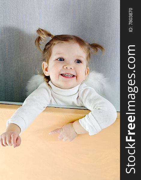 Stock photo: an image of a baby with white wings. Stock photo: an image of a baby with white wings