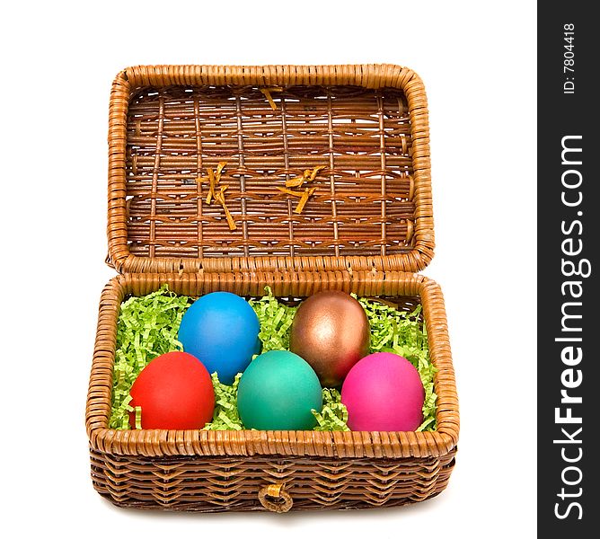 Five coloured Easter eggs in a rectangular straw casket. Five coloured Easter eggs in a rectangular straw casket