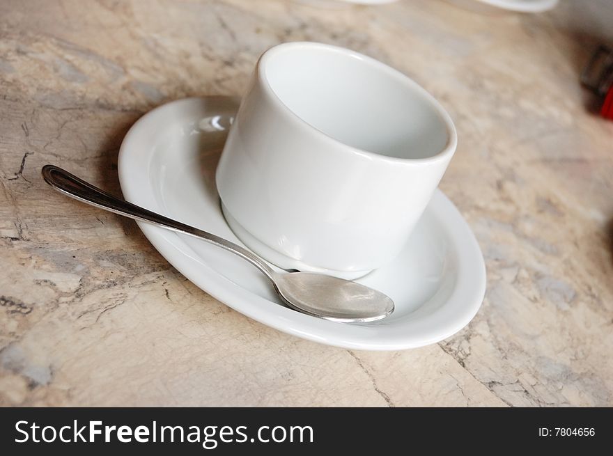 Empty white tea or coffee cup and spoon. Empty white tea or coffee cup and spoon