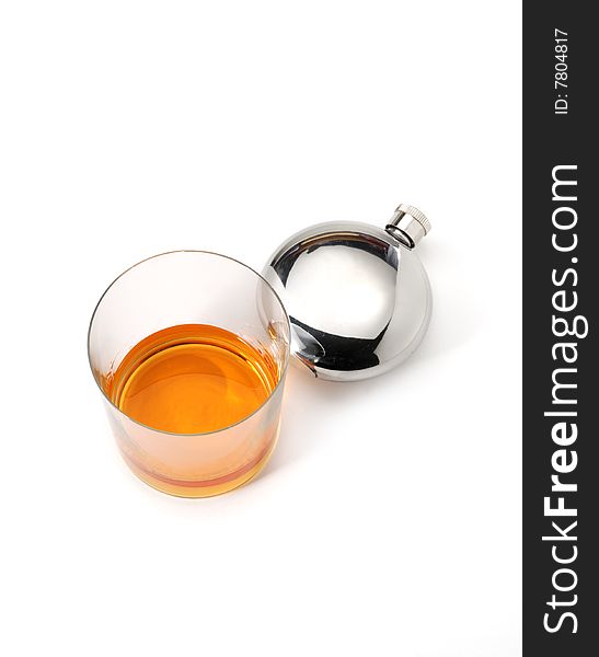 A glass of whiskey and a little bottle isolated over white. A glass of whiskey and a little bottle isolated over white