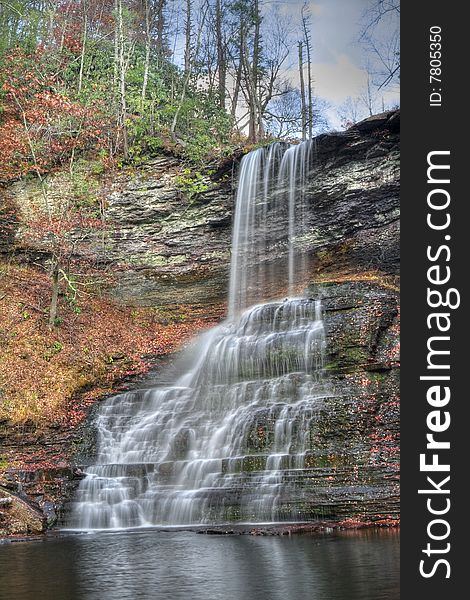 Beautiful large waterfall falling into a lagoon during autumn. Beautiful large waterfall falling into a lagoon during autumn.