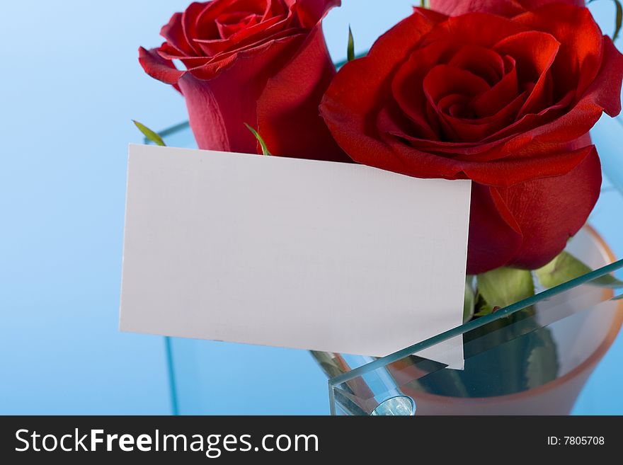 Red roses in the vase and note on it. Red roses in the vase and note on it