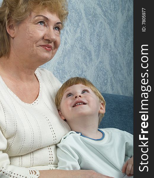 Portrait of the grandmother with the grandson in house conditions