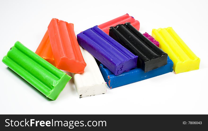 Plasticine, several different colours, on white background