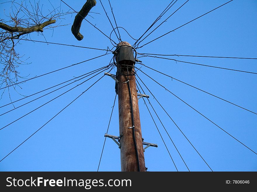 Telephone pole and lines against a blue sky