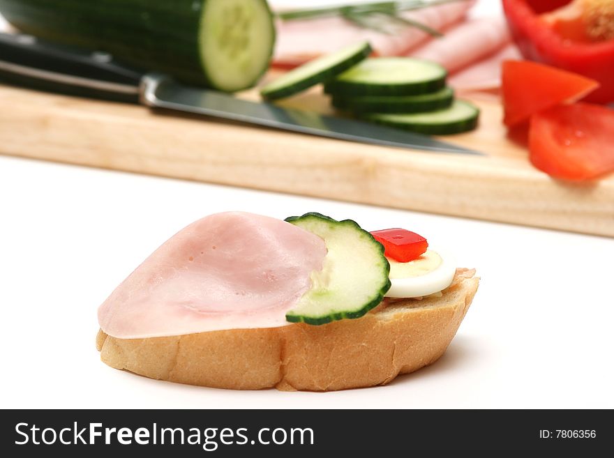 Ham,cucumber,egg and bread on white. Ham,cucumber,egg and bread on white