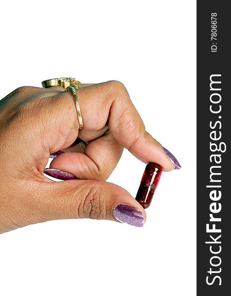 Capsule in female hand over white background.