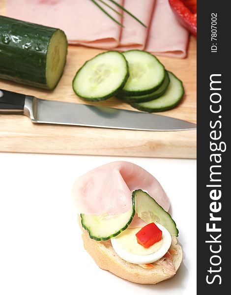 Ham,cucumber,egg and bread on white. Ham,cucumber,egg and bread on white