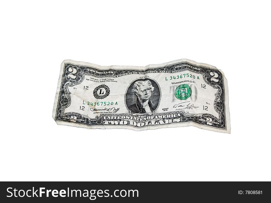The crumbling two dollar bill isolated over a white background.
