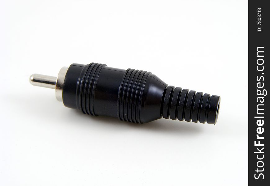 Black phono (RCA Jack) type plug on a plain background. Black phono (RCA Jack) type plug on a plain background