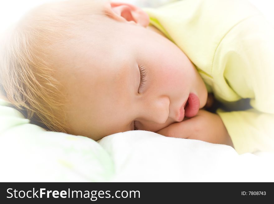 Restful baby boy sleeping on bed