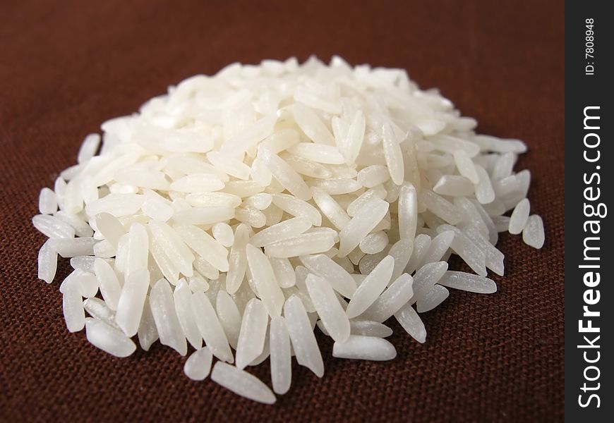 Heap of rice on brown background