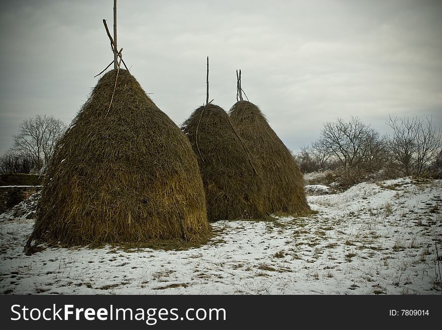 Haystack in winter in a village