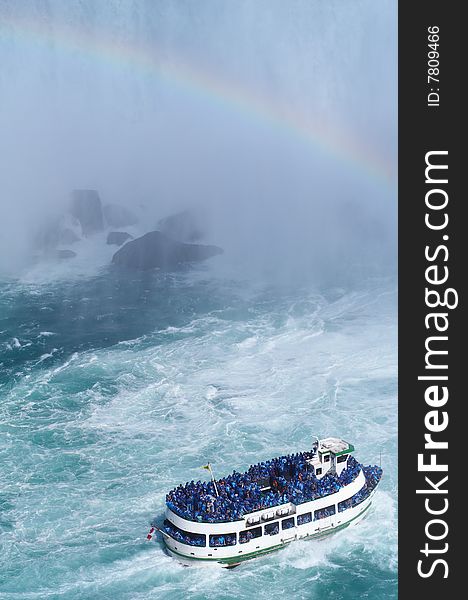 Ship near Niagara Fall with rainbow at the background