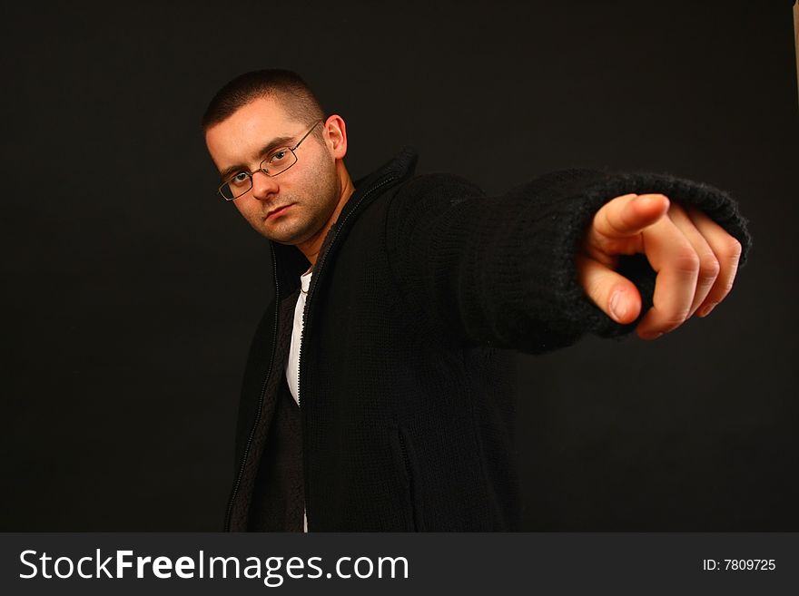 Young relaxed casual man pointing with his finger