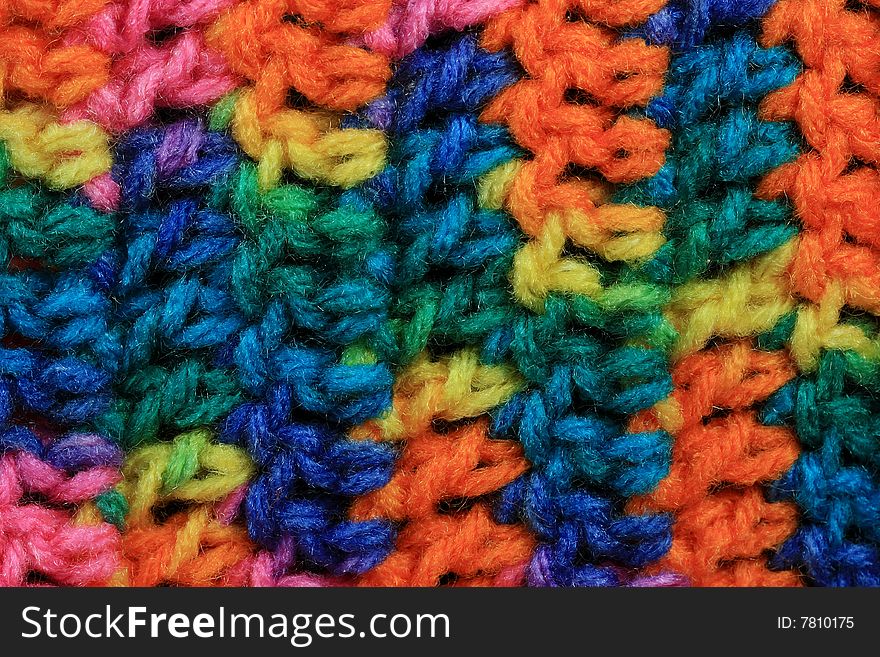 Textured brightly colored stitches of crochet background.