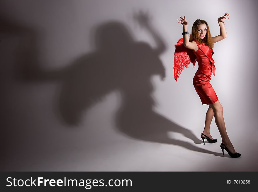 Young girl in red dress with wings. Young girl in red dress with wings