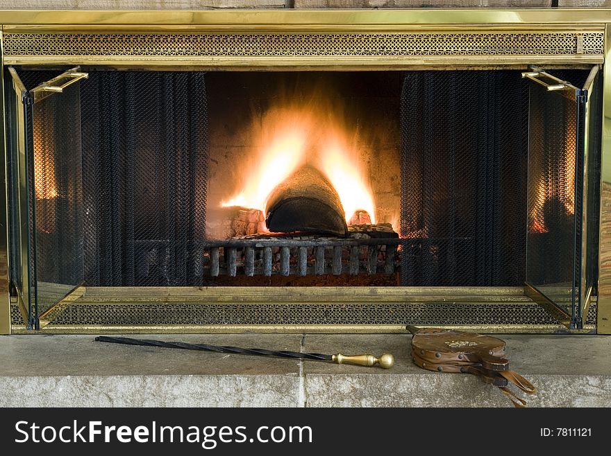 Classic fireplace with bellows and a poker ready for assistance. Classic fireplace with bellows and a poker ready for assistance.