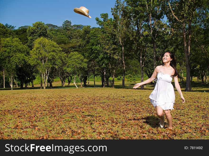 A beautiful asian girl enjoying the outdoor sun. A beautiful asian girl enjoying the outdoor sun